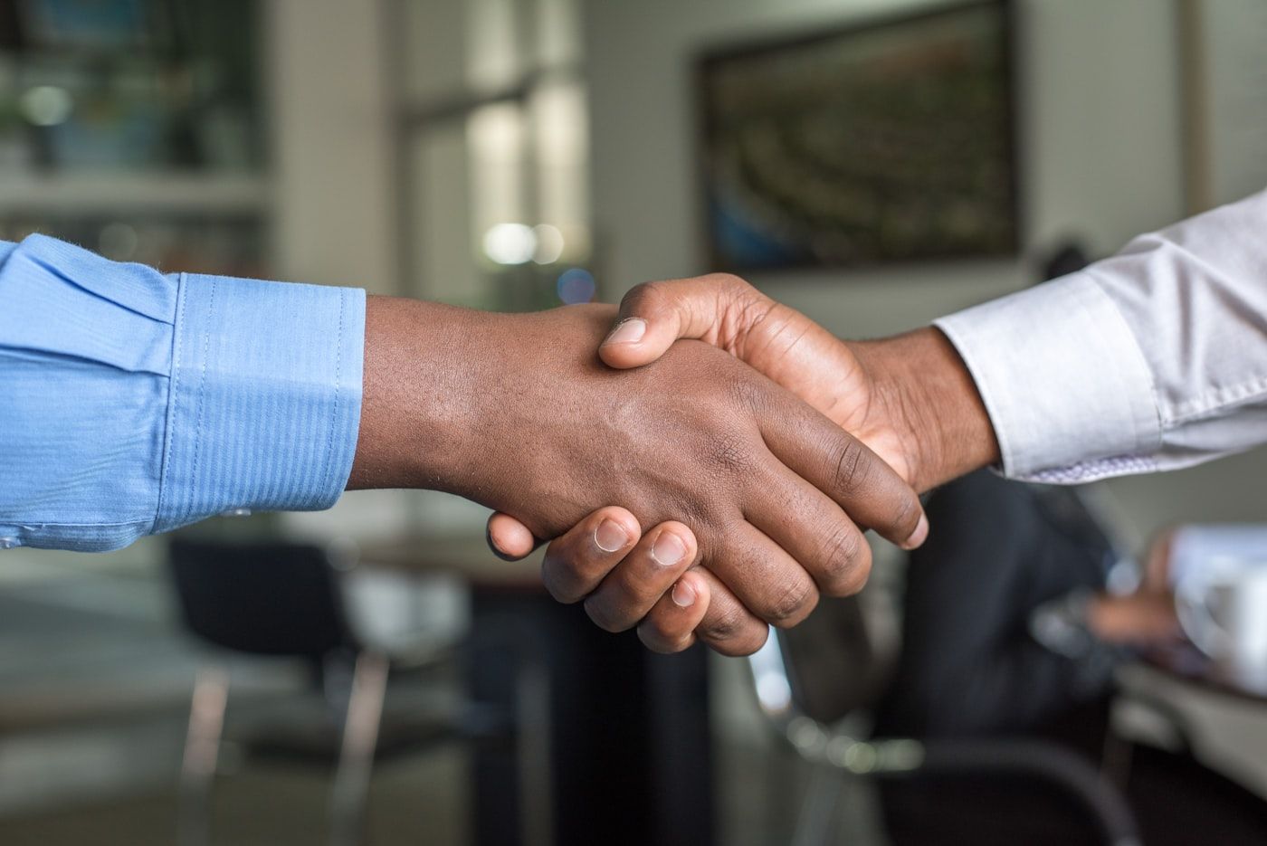 A handshake sealing a business partnership in Kampala